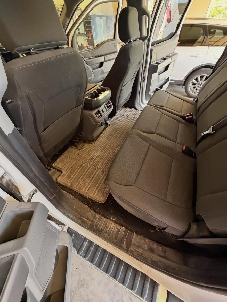 Truck rear seats before detailing — dirty floor mats