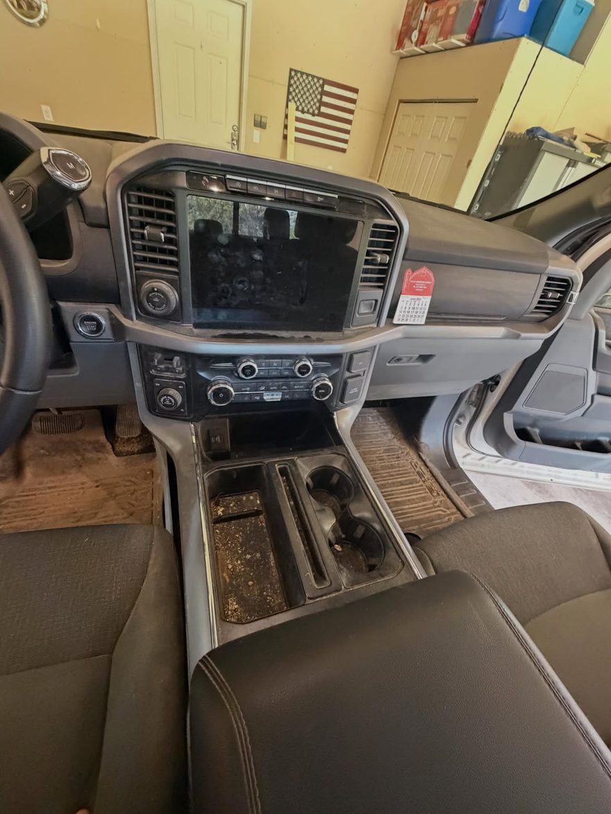 Truck dash and console before detailing — dirty console