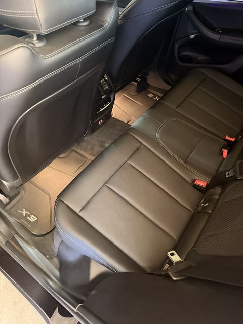 BMW X3 rear seats and floor mats vacuumed and wiped down